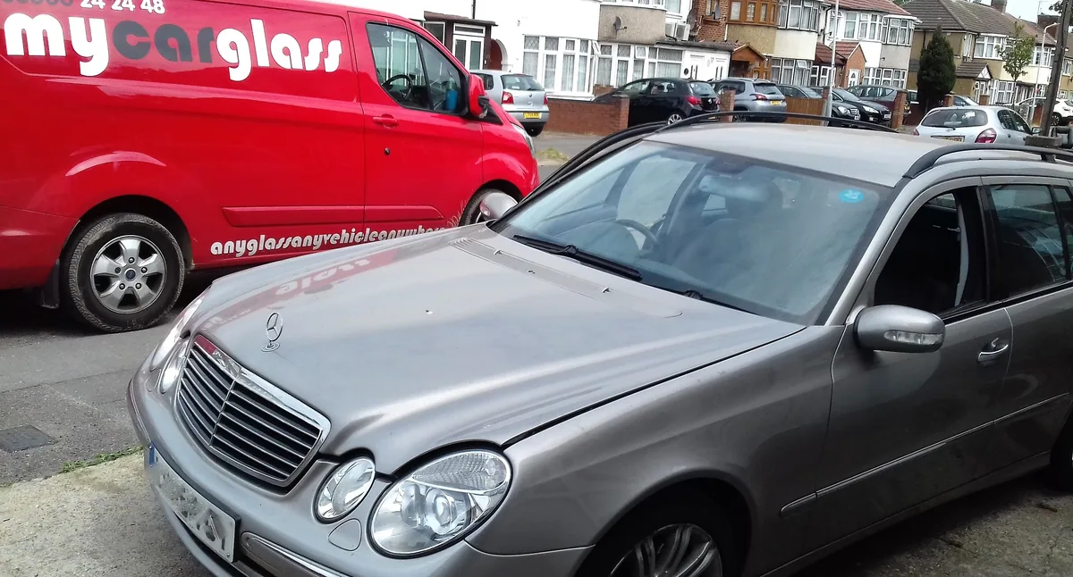 Classic Mercedes saloon outdoors after gasket-fitted windscreen replacement.