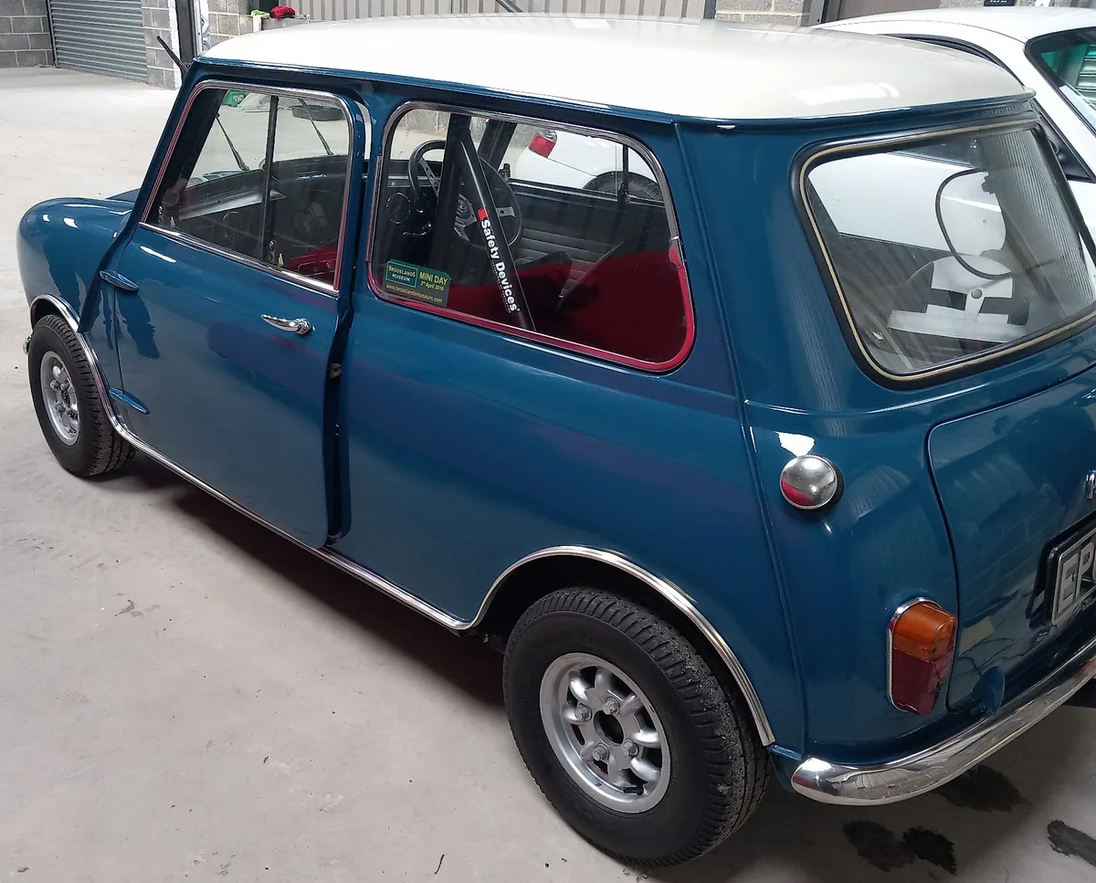 Classic blue Mini with replacement windscreen fitted into the rubber gasket.