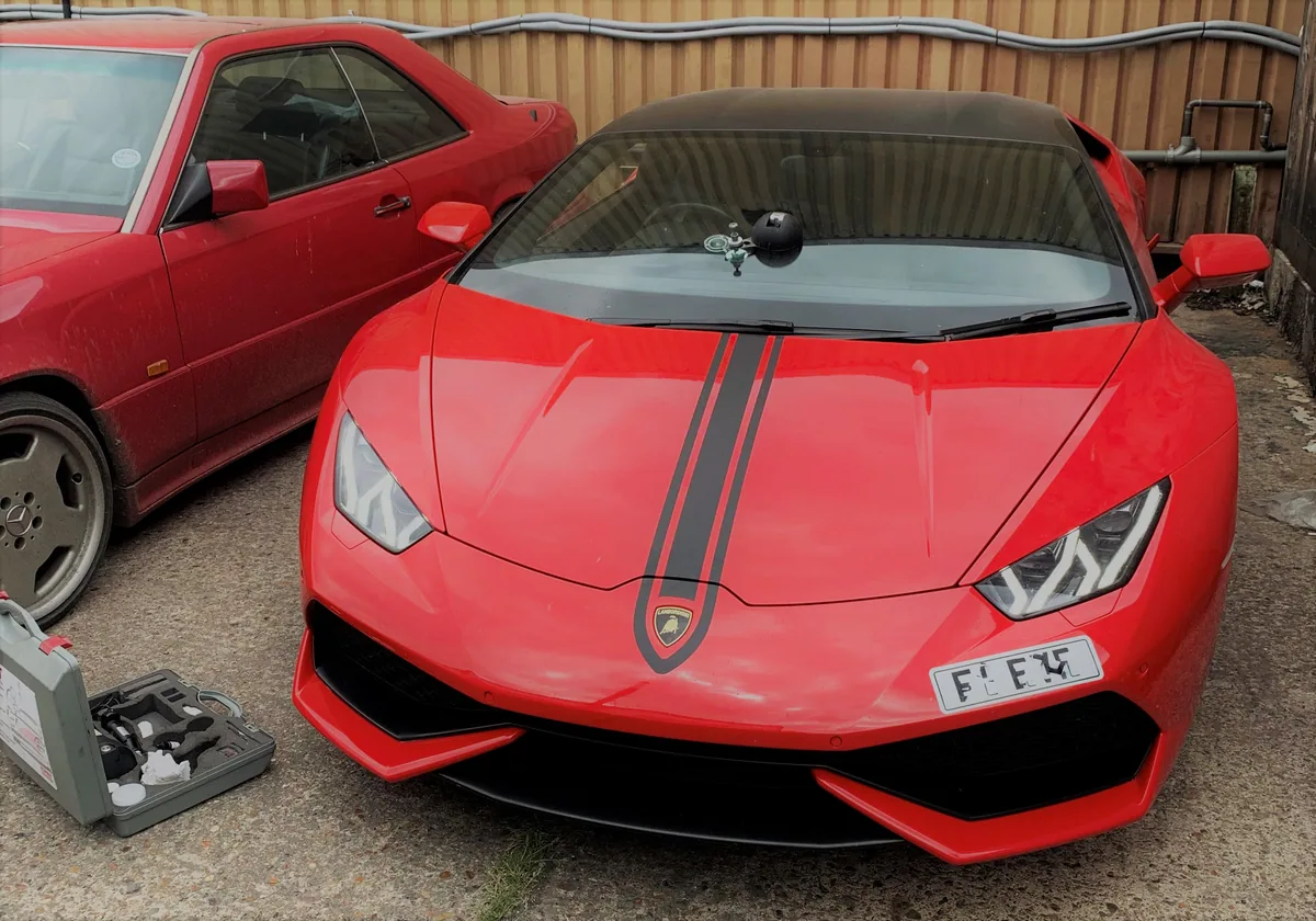 Close view of a Lamborghini Huracán windscreen chip with the repair bridge in place.