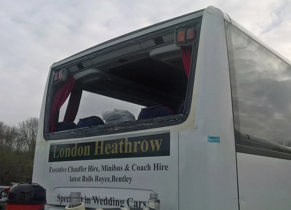 Mercedes Tourismo coach during side window replacement at the depot.