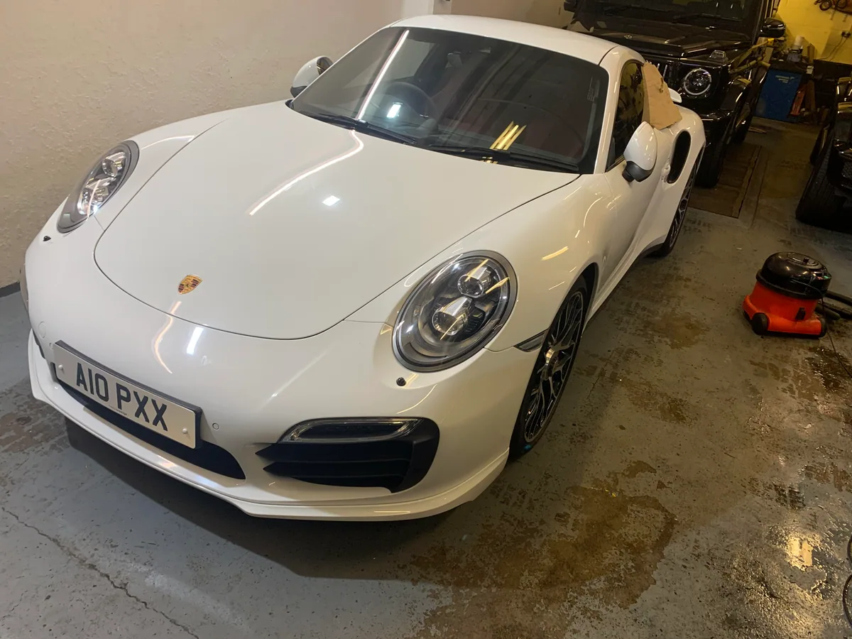 Porsche 911 quarter glass replacement — old panel removed.
