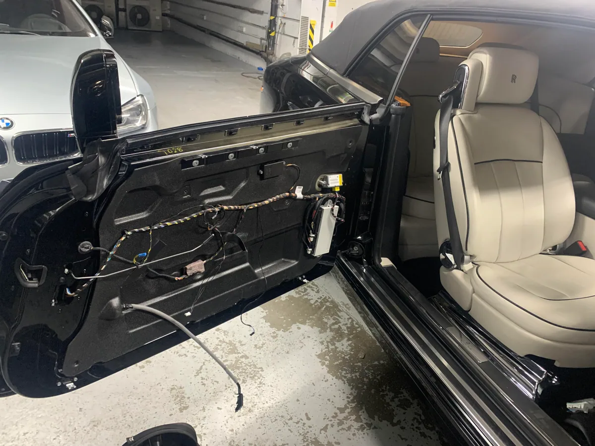 Rolls-Royce Phantom door trim carefully removed during glass replacement.