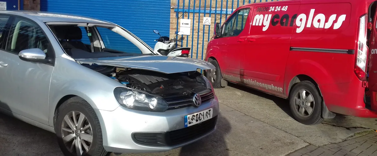 Saloon car during windscreen replacement at the workshop.