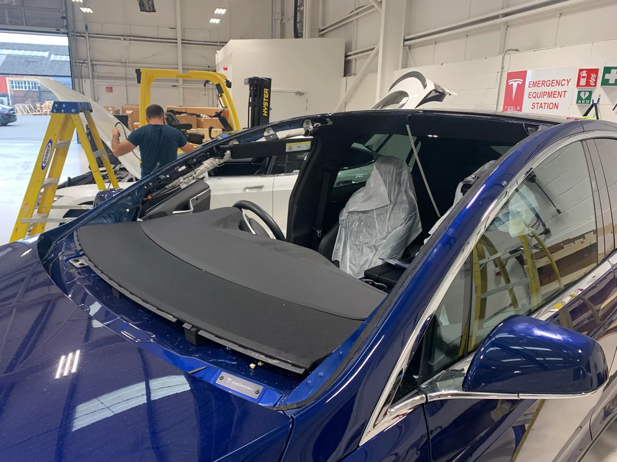 Tesla Model X in the workshop with the windscreen removed.