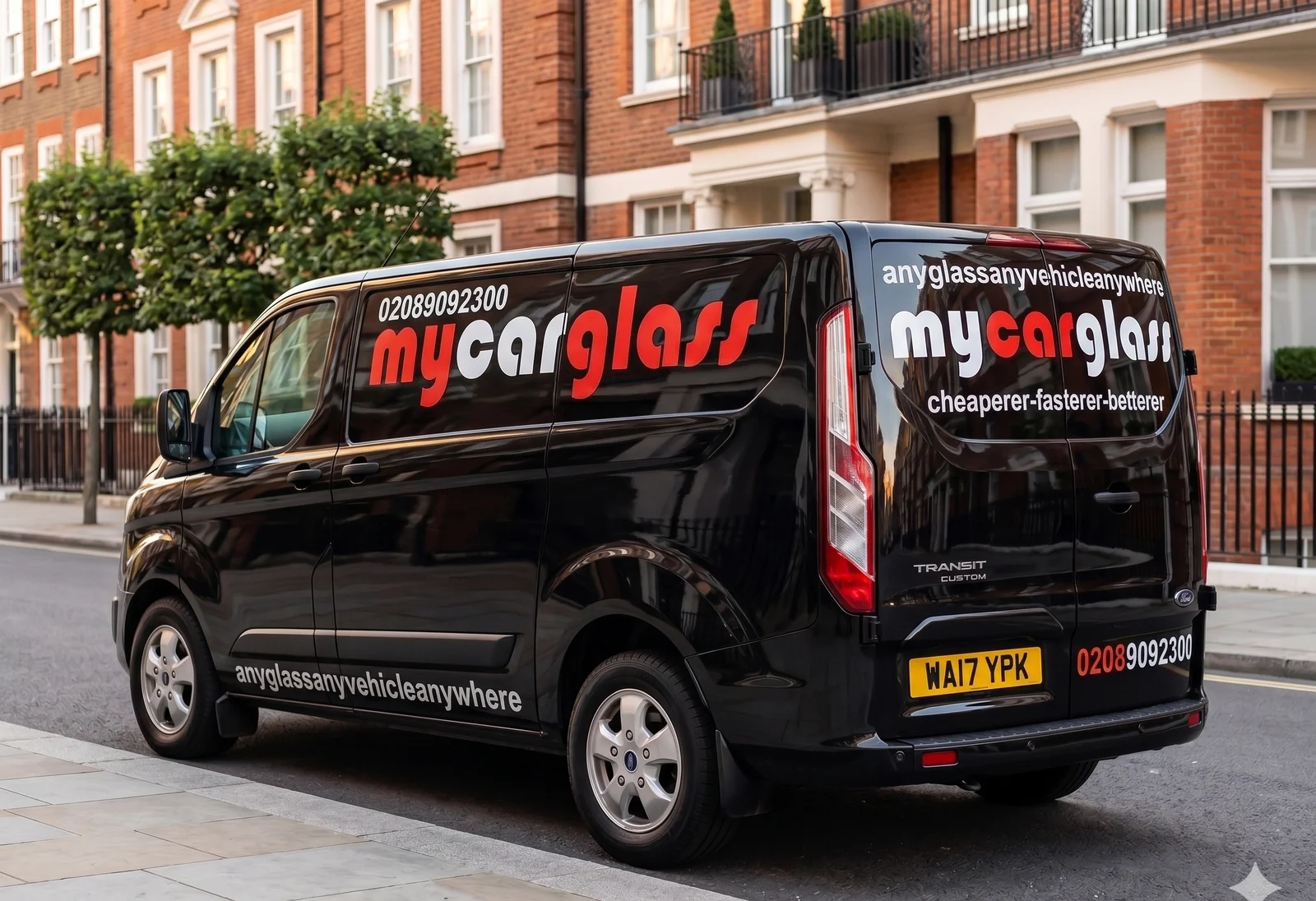 The black MyCarGlass Ford Transit van parked on a residential London street.